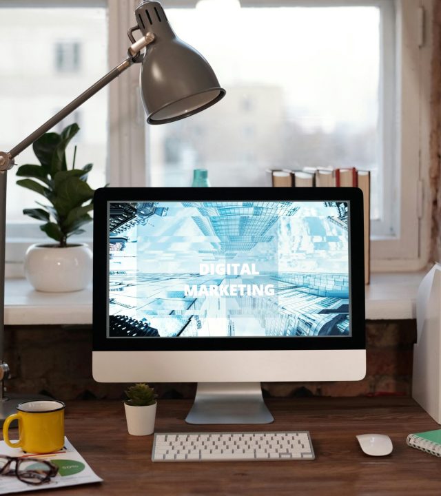 Contemporary home office desk with digital marketing screen, perfect for remote work inspiration.